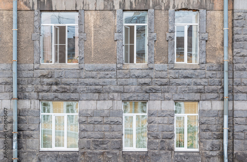 Several windows in a row on facade of urban office building front view, St. Petersburg, Russia.