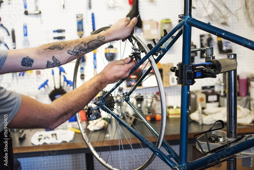 Man working in bicycle repair shop photo