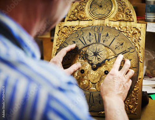 A clock maker displaying his work. photo