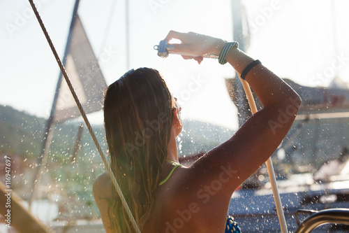 Back side of young female showering on the yacht
Vintage efect