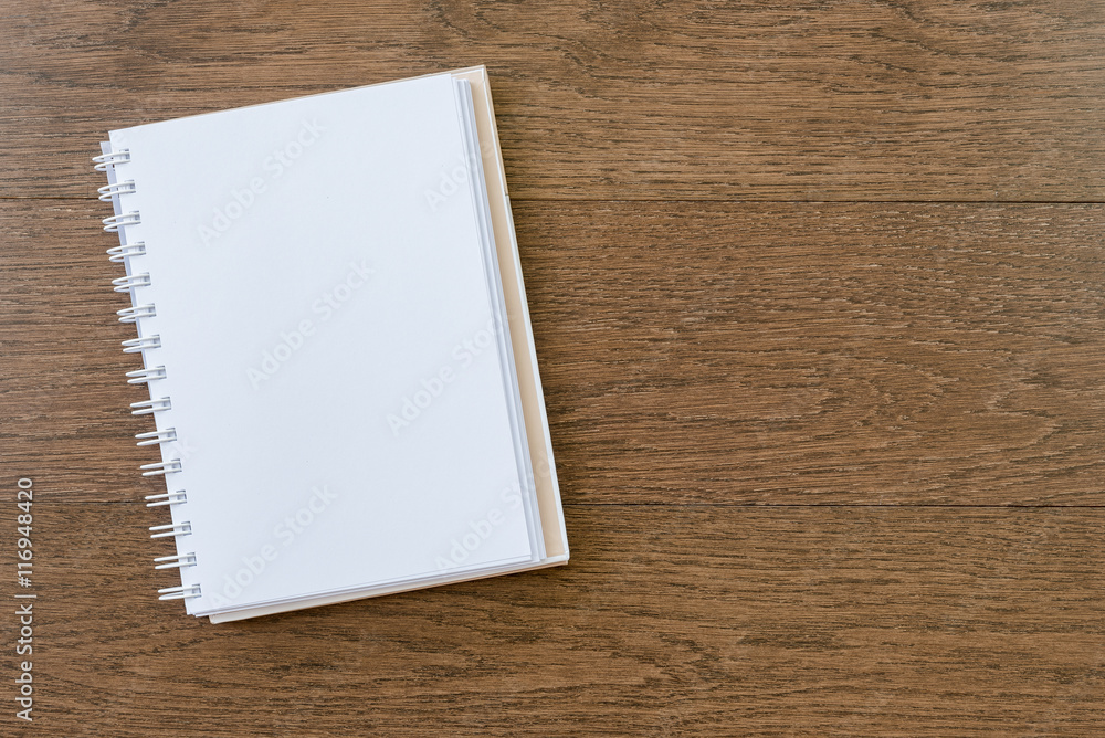 blank white notebook on wooden texture background blank white notebook on wooden texture background
