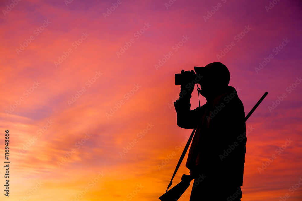 Rifle Hunter Silhouetted at Sunrise