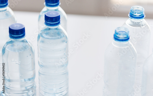 close up of bottles with drinking water on table