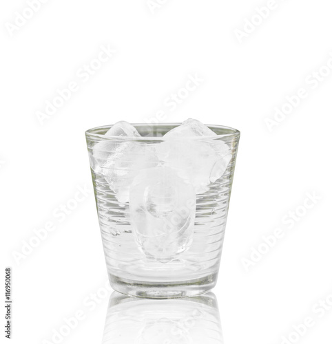 Glass with ice cubes on the table