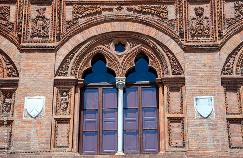 artistic window in a red brick wall, Pisa, italy