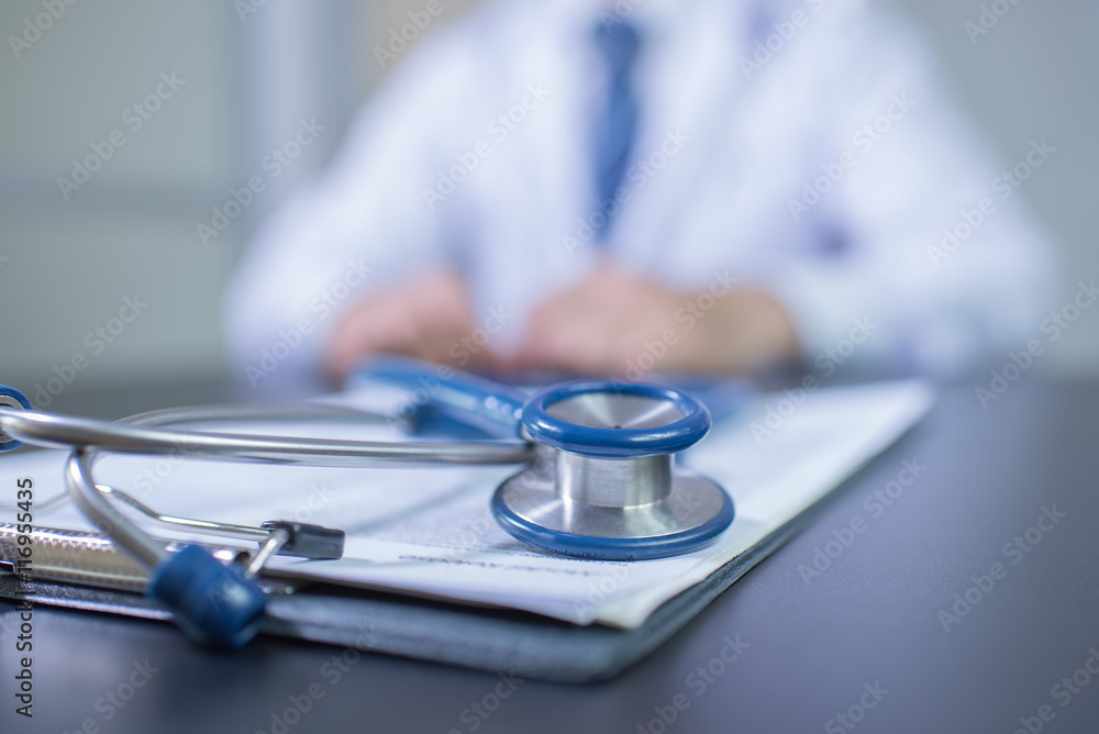 Medicine doctor's working table. Focus on stethoscope Medicine doctor's working table. Focus on stethoscope