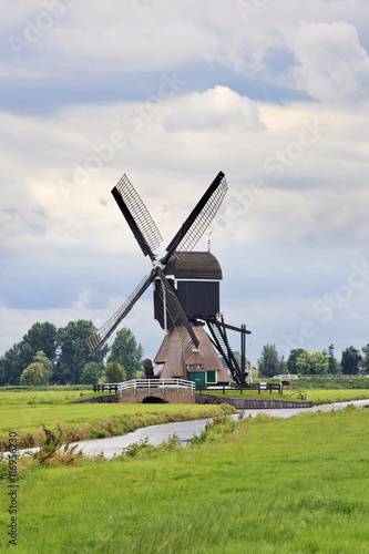 Ancient wooden windmill near small canal  Kinderdijk  The Netherlands