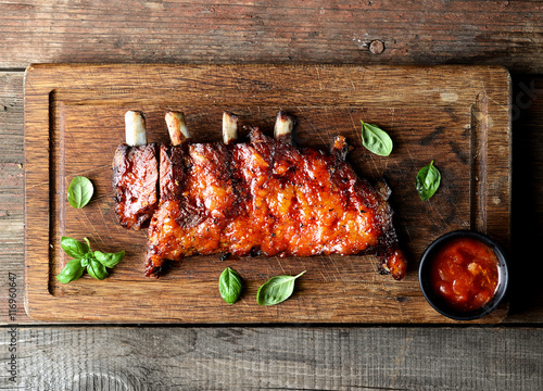 grilled ribs on a cutting board. rustic style