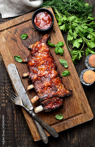 grilled ribs on a cutting board. rustic style