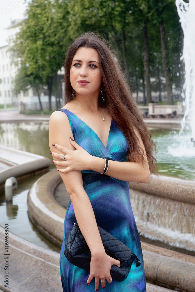 beautiful young brunette woman in a blue dress beautiful young brunette woman in a blue dress