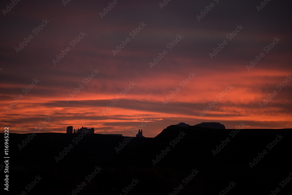 Red sunset in Goosenecks park showing Monument Valley of Arizona