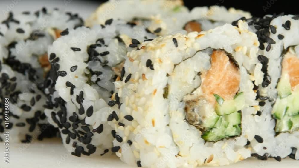 On the table laid out rolls or sushi with sesame. Close up On the table laid out rolls or sushi with sesame. Close up