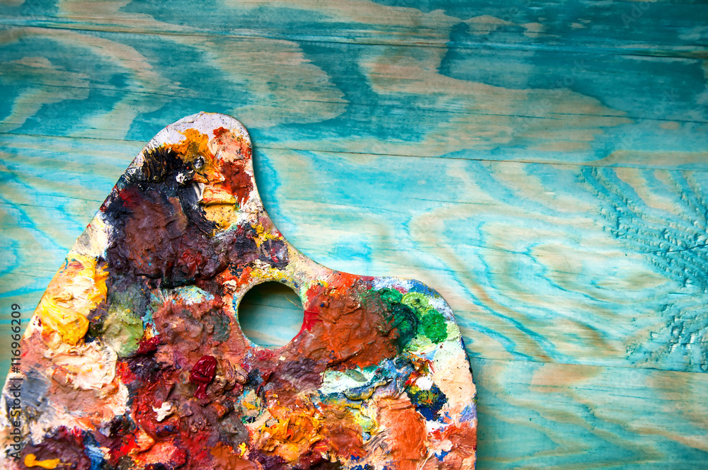 Obraz premium Painting palette on colorful wooden background