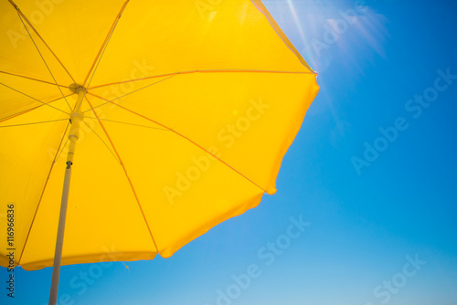 yellow umbrella on blue sky