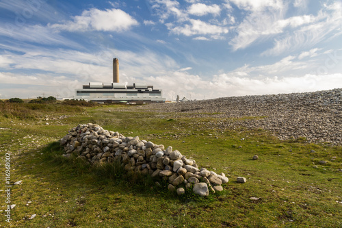 Pile of stones, power station in distance photo