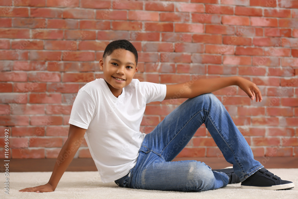 African American boy on brick wall background African American boy on brick wall background