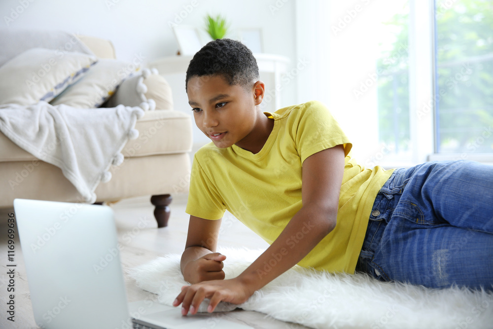 African American boy with laptop at home African American boy with laptop at home