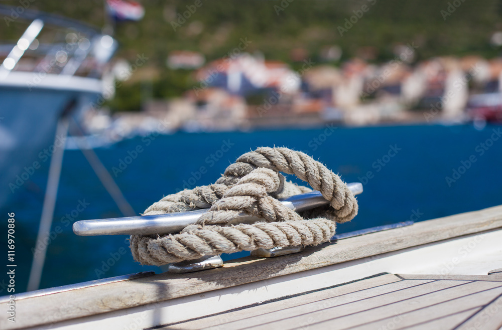Marine knot detail on stainless steel boat railing banister. Sailboat details