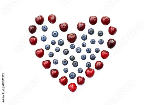 Isolated heart of cherry and blueberry on a white background