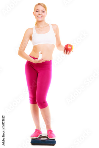 Woman holding vitamins and apple. Health care.