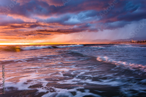 Dramatic stormy sunset and waves in the Pacific Ocean, seen at V
