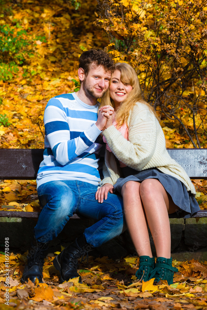 Lovers couple in autumn park on bench Lovers couple in autumn park on bench