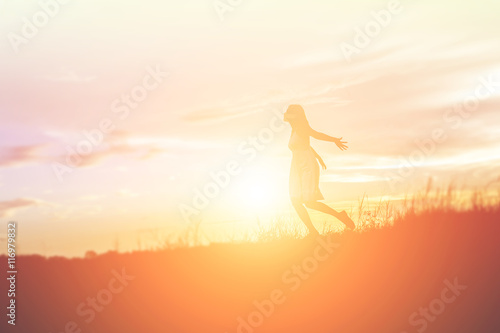 Silhouette of a beautiful girl jumping