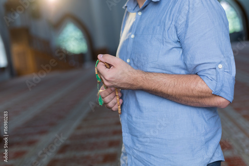 hand holding a muslim rosary photo