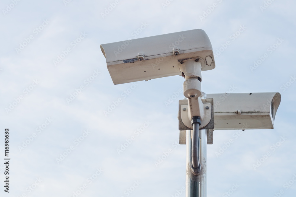 Outdoor security CCTV camera on blue sky background Outdoor security CCTV camera on blue sky background