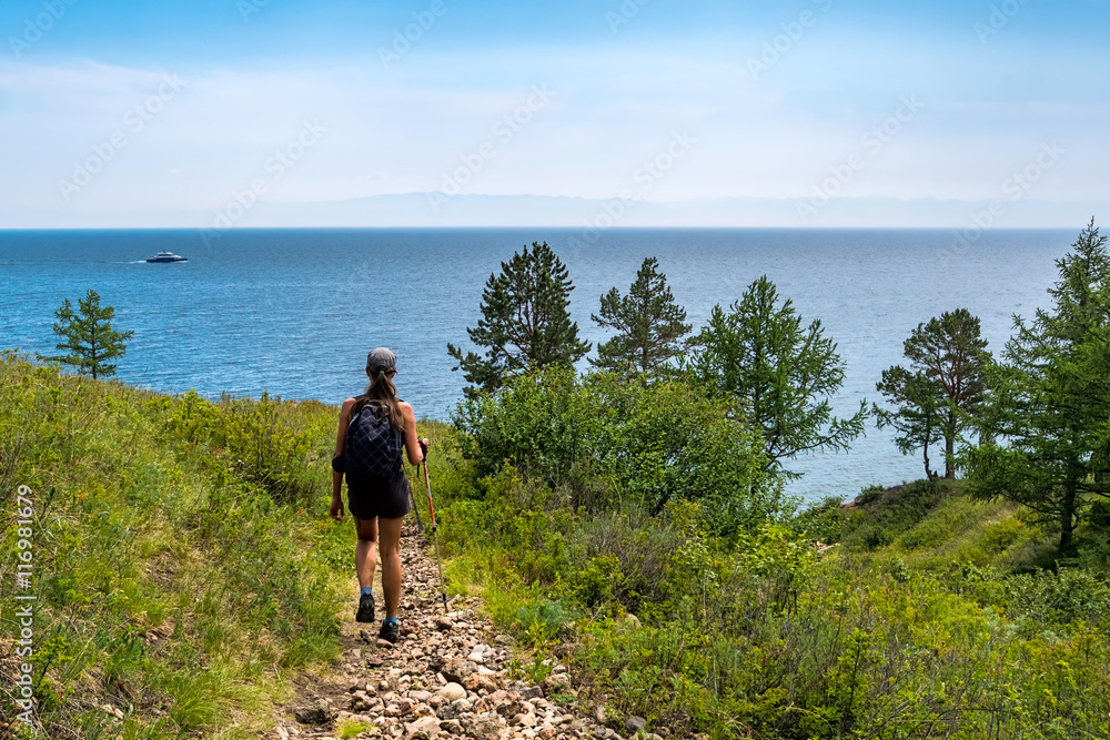 girl goes on the trail leading to Lake Baikal