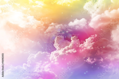 Colourful dreamy puffy clouds sky with lense flare photo