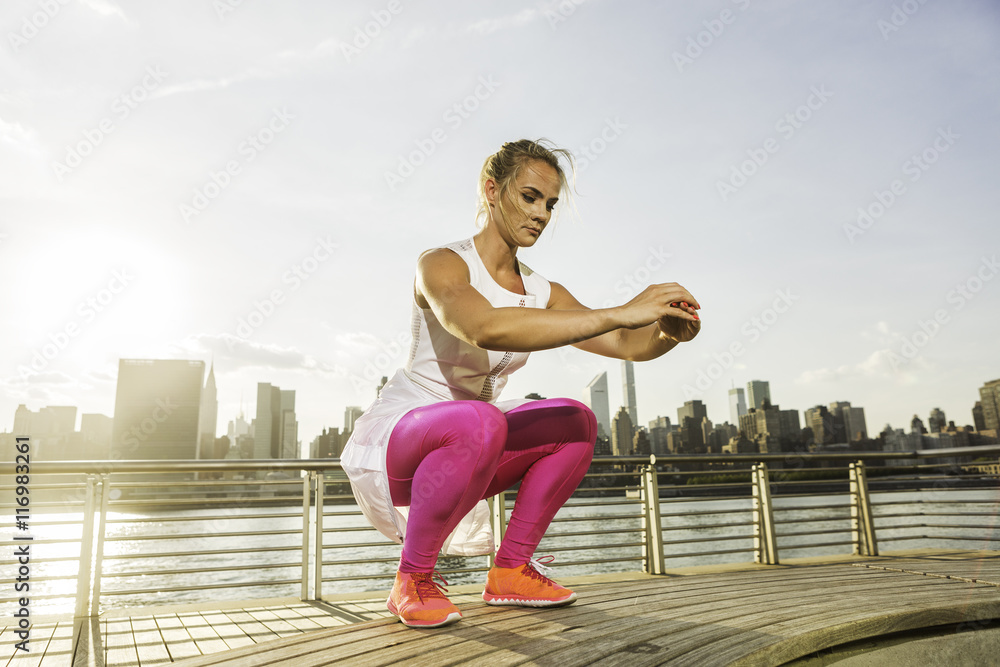 Fitness instructor working out in the park by the river