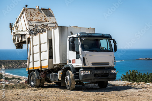 White recycling truck stays near Paleochora town on Crete island, Greece