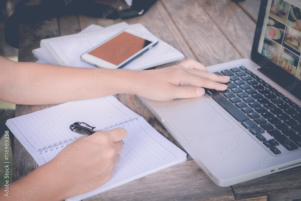 business woman and laptop and write on notebook. business woman and laptop and write on notebook.