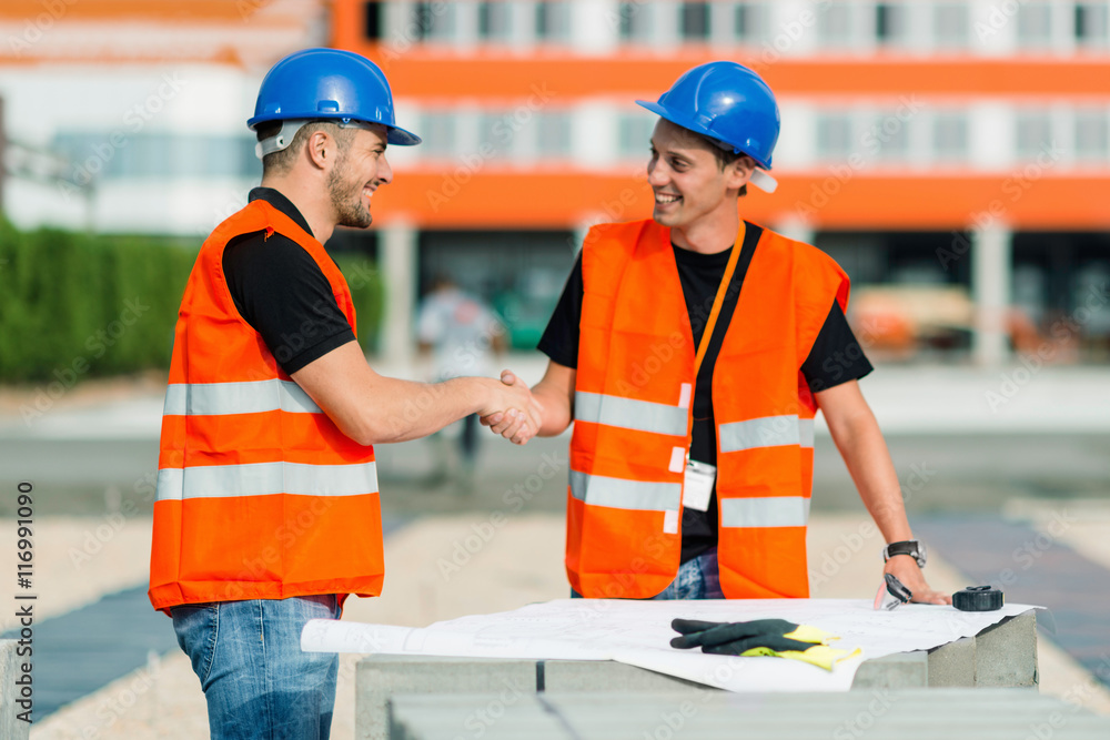 Engineer and foreman making a deal at the construction site Engineer and foreman making a deal at the construction site