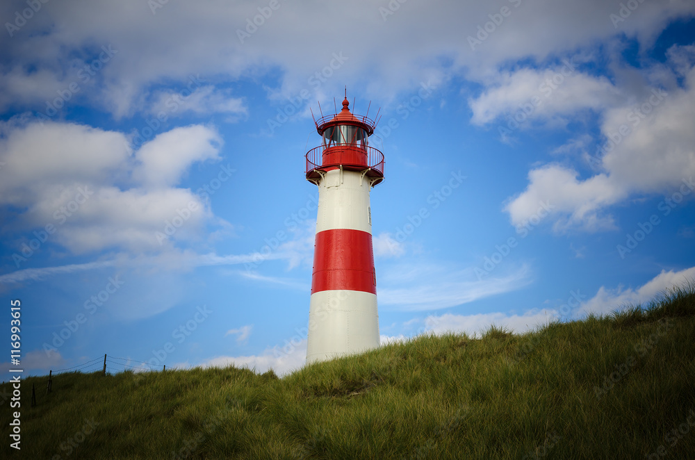Lighthouse on the Dune.
 Lighthouse List East on a dune of the island Sylt, Germany, North Sea, strong vignette.