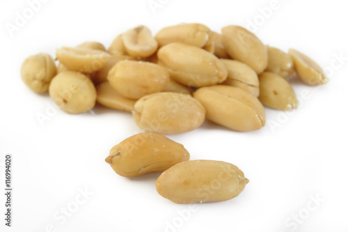 Peeled salted peanuts isolated on white background