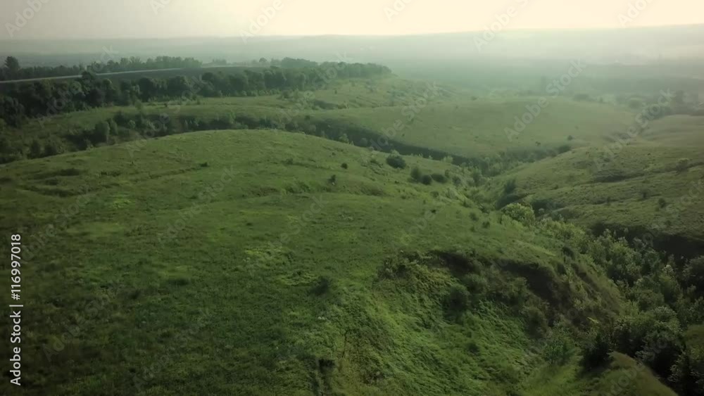 AERIAL:flying over foggy valley (video filmed with quadcopter drone)