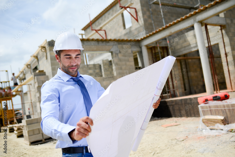 portrait of handsome young man architect on a building industry construction site portrait of handsome young man architect on a building industry construction site