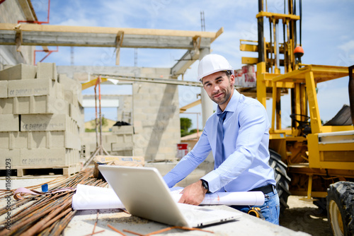 portrait of handsome young man architect on a building industry construction site © W PRODUCTION