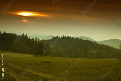 Hills and forest at autumn sunrise