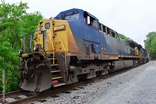 An Americam Diesel locomotive freight train waiting at a signal stop before it moves off.