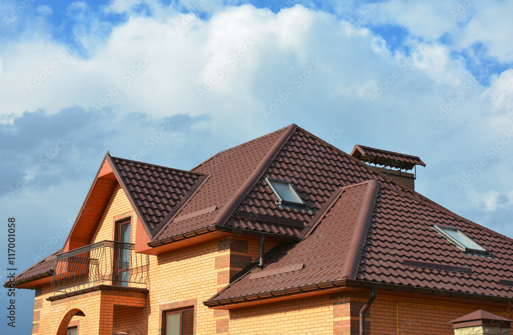 New roofing construction with attic skylights, rain gutter system, roof windows and roof protection from snow board, snow guard house exterior.