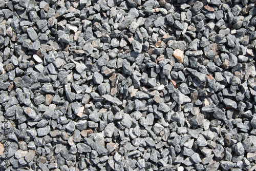 Background composed of crushed gravel fine fraction in sunlight