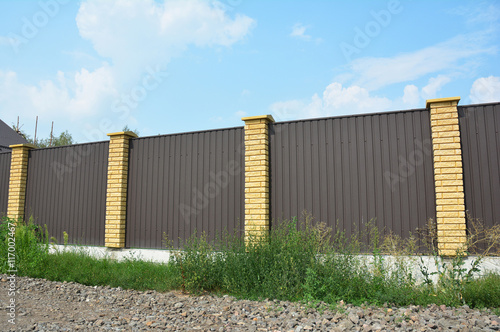 Long metal fence on the suburban street side