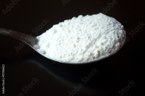 spoon of flour on the black background