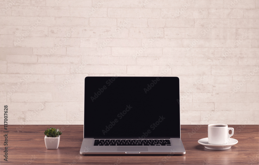 Office desk closeup with white brick wall Office desk closeup with white brick wall