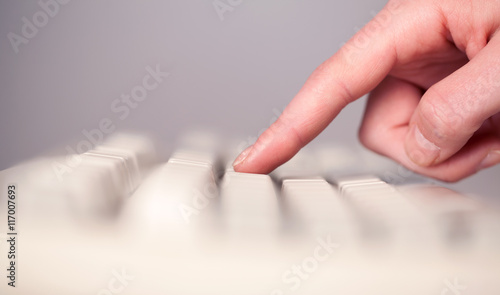 Close up of hand pressing keyboard buttons