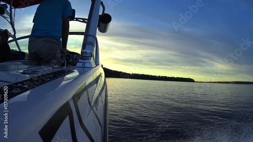 Boat Driver Standing Back View, Young people hanging out on a wakeboard sport boat in the summer