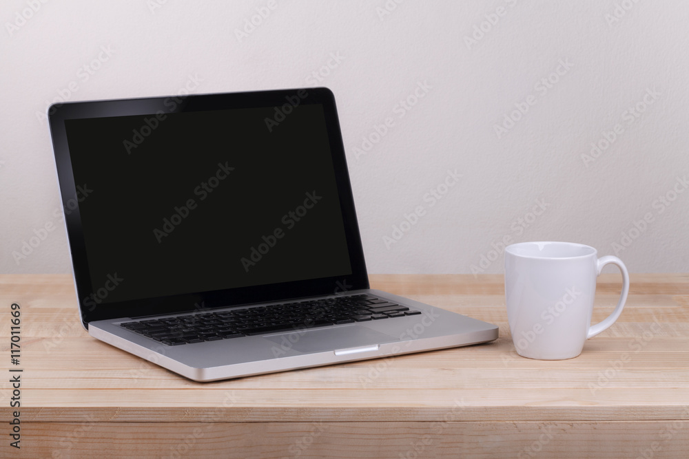 Front view of the laptop is on the work table concrete backgroun Front view of the laptop is on the work table concrete backgroun